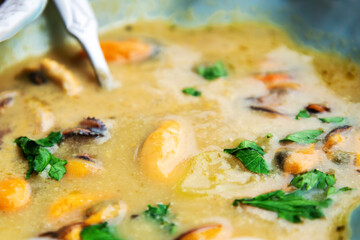 Traditional homemade greek mussels spicy soup cooked with olive oil and mustards