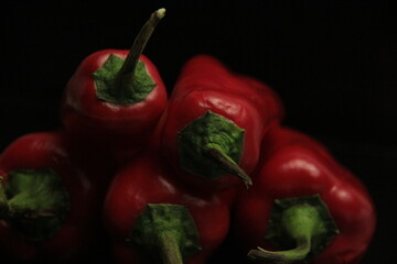 fresh organic peppers on a black background