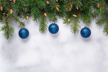 Fototapeta na wymiar Christmas background with fir branches and blue balls.