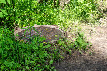 Cast iron sewer manhole in a city Park