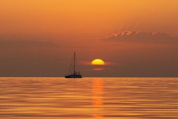 Fototapeta premium Summer Serenity: Catamaran Journey at Sunrise