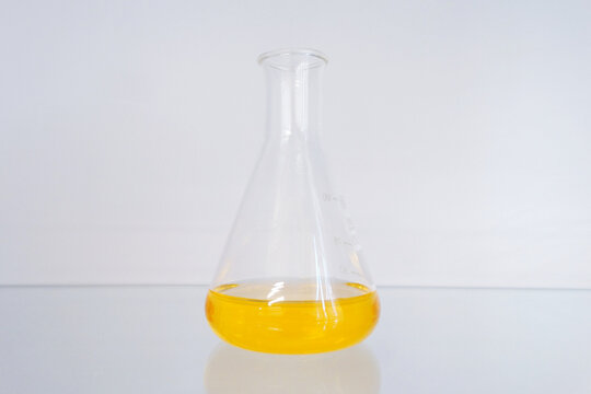 yellow chemical solution in a conical flask