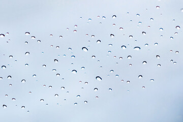 Rainy season. Rain drop on the glass of the window.
