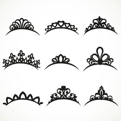 Set of silhouettes of tiaras of various shapes on a white backgr © Azuzl