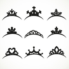 Set of silhouettes of tiaras of various shapes on a white background © Azuzl