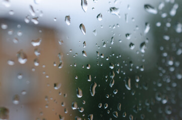 Abstract rain droplets on a window with center of the picture in close-up for extra detail.
