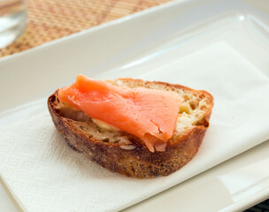 delicious canapes of salted, smoked salmon fillet on slice of fresh ciabatta bread