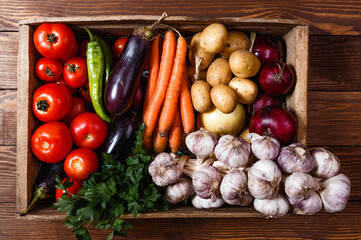 Vegetables and greens on a wooden table. Plant foods for the elderly. Vegan table. View from above