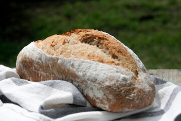 Homemade sourdough bread on authentic cloth .