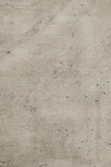 Cream-colored old marble-style concrete wall with cracked and weathered areas.