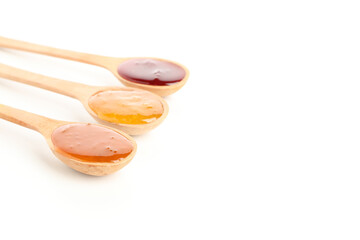 Spoons with jam isolated on white background