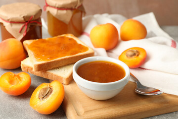 Composition with apricot jam on gray table, close up