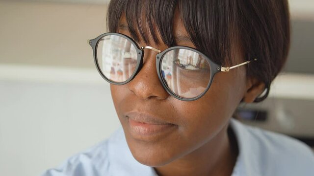 Beautiful black woman smiling, wearing eyeglasses for eye sight correction