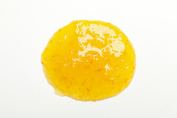 Apricot jam isolated on white background, close up