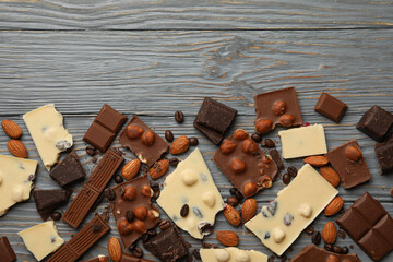 Different chocolate on gray wooden background, top view