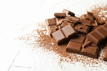 Tasty chocolate and powder on white background. Sweet food