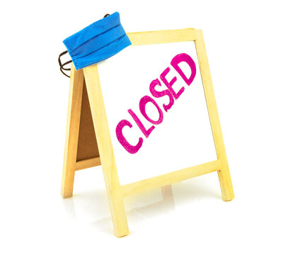 Coronavirus concept with text closed, announcement on board, blackboard, chalkboard, frame and blue protective medicine surgical equipment mask. Isolated on white background.