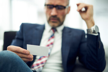 Male entrepreneur holding modern visit card with selective focus, made by creative web designers...