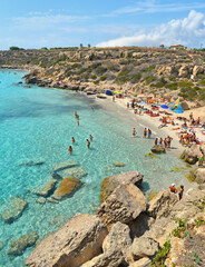  paradise clear turquoise blue water with rocks in Favignana island, Cala Azzura Beach, Sicily South Italy.