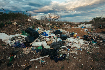 Illegal landfill in the middle of the forest and field. 