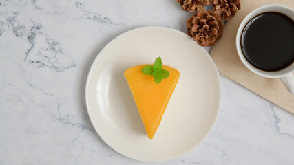 Orange cake and coffee on white mable background. Top view