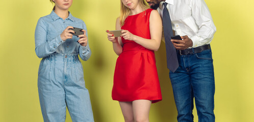 Group of friends using mobile smartphones. Teenagers addiction to new technology trends. Close up. Millenials texting, scrolling, chatting, watching video or shopping online. Connecting with devices.