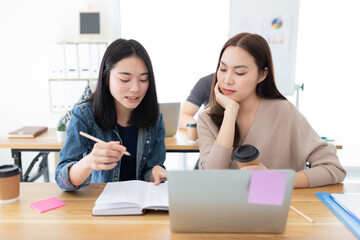 attractive asian female officer reviews information of organization performance, they sharing...