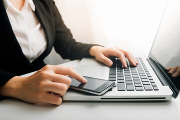 businesswoman hand using smart phone, tablet payments and holding credit card online shopping, omni channel, digital tablet docking keyboard computer at office in sun light