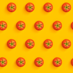 Diagonal pattern from ripe juicy tomatoes on bright yellow background. Creative minimalist flat lay. Vitamins vegan healthy diet concept