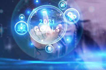 Business, Technology, Internet and network concept. Young businessman working on a virtual screen of the future and sees the inscription: 2021 goals