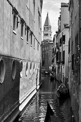Fototapeta premium Narrow canal with gondolas in Venice
