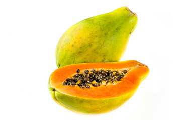 Raw juicy fresh papaya fruit isolate on a white background. Half and whole papaya on a white table