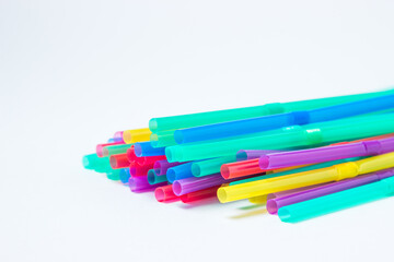 Colored cocktail straws lie on a white background. Holiday concept. Background for an inscription.