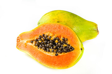Raw juicy fresh papaya fruit isolate on a white background. Half and whole papaya on a white table