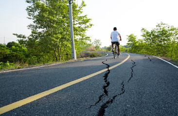 Obraz premium The picture of the broken asphalt road. Look dangerous when riding on it