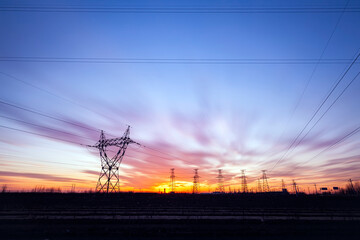 In the evening, the high voltage tower and the beautiful sunset glow