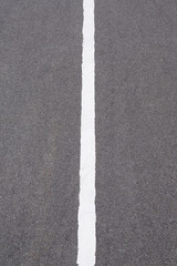 Fototapeta premium White solid line on asphalt road. Carriageway marking