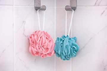 Pink and blue shower scrubbers