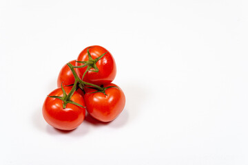 Red tomatoes on a branch on a white background, top view