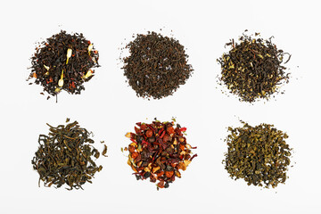 different types of tea scattered on a light gray background. tea shop concept. tea party concept. concept of different tastes and choices. top view, flat lay.