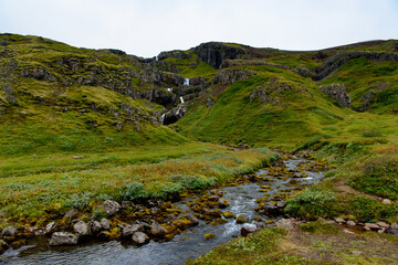 Klifbrekkufossar, beautiful row of waterfalls, in Mjoifjordur village, Iceland
