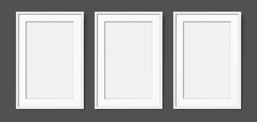 3 white wooden frames with passepartout, hanging on the dark wall background. Realistic blank frames mockup, for text or image placement. Empty elegant frames vector template with copy space.