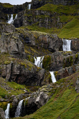 Klifbrekkufossar, beautiful row of waterfalls, in Mjoifjordur village, Iceland