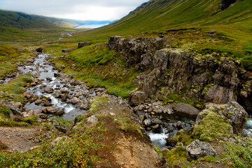 Fototapeta na wymiar Klifbrekkufossar, beautiful row of waterfalls, in Mjoifjordur village, Iceland