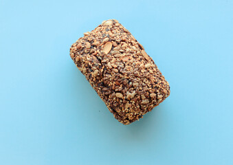 Sliced whole grain bread rye with seeds flax, sunflower, pumpkin and sesame.Healthy food, eco-friendly natural products. Fresh bread on a pink background.