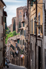 Siena, Tuscany, Italy, April, 2018: Old narrow street in the historic city center of Siena, Tuscany, Italy
