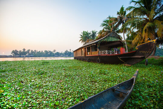 Beautiful sunset with houseboat in the backwaters of Kerala, India