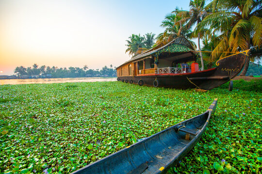 Beautiful sunset with houseboat in the backwaters of Kerala, India
