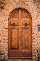 beautiful door in a street of old medieval village in Tuscany