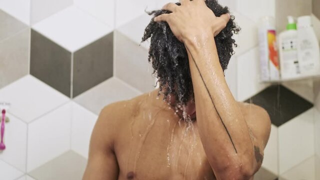 African Guy Washing His Hair Indoors In A Bathroom